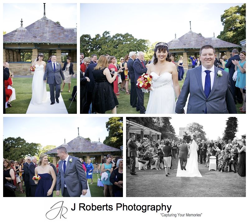Very excited bride and groom walking down the aisle at the rose gardens - sydney wedding photography 